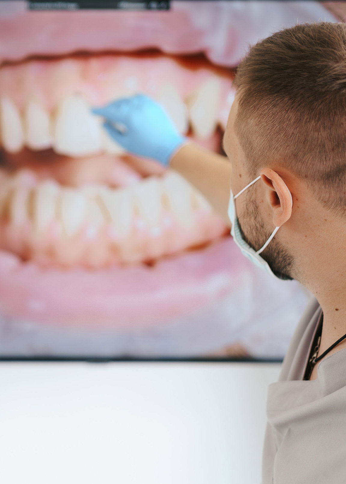 A dentist examining detailed clinical imagery